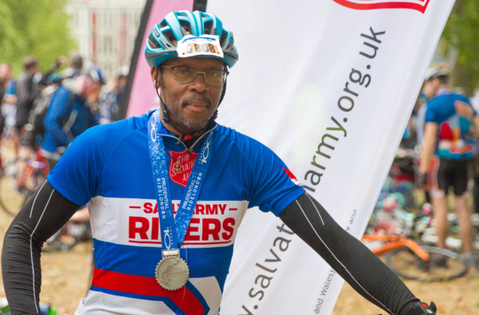 Man with medal after completing Ride London
