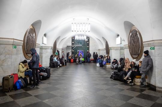 People with luggage in a Kyiv Ukraine subway