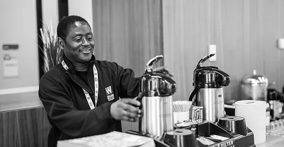 William Booth College staff preparing the coffee and tea station at the hub.