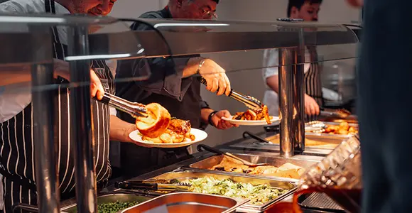 Canteen staff serving delicious food.