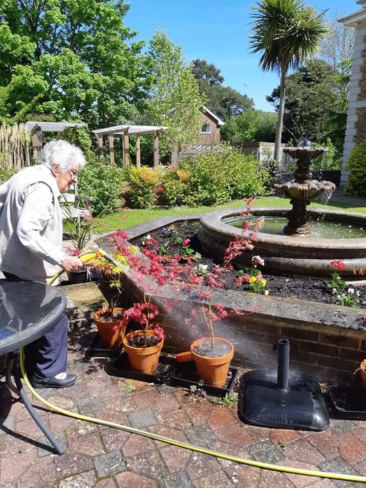 Resident watering the plants