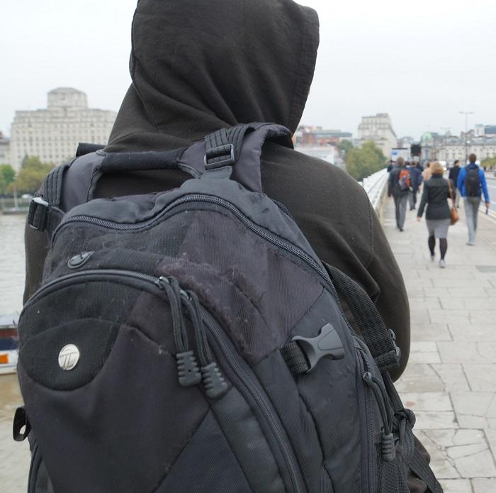 Hooded person with rucksack
