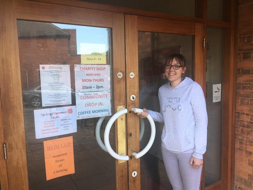 Jade standing at door to local Salvation army shop