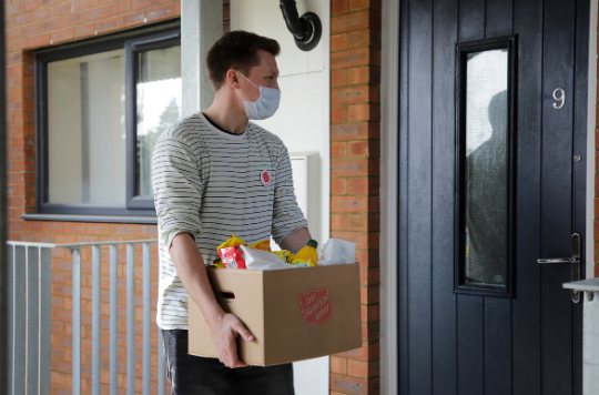 Salvation Army volunteer delivers a food parcel