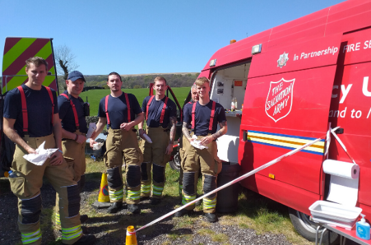 Fire fighters receive refreshements from a Salvation Army van