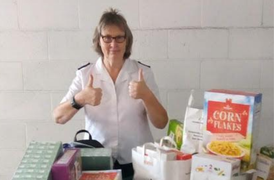 Salvation Army leader with trollies full of breakfast food
