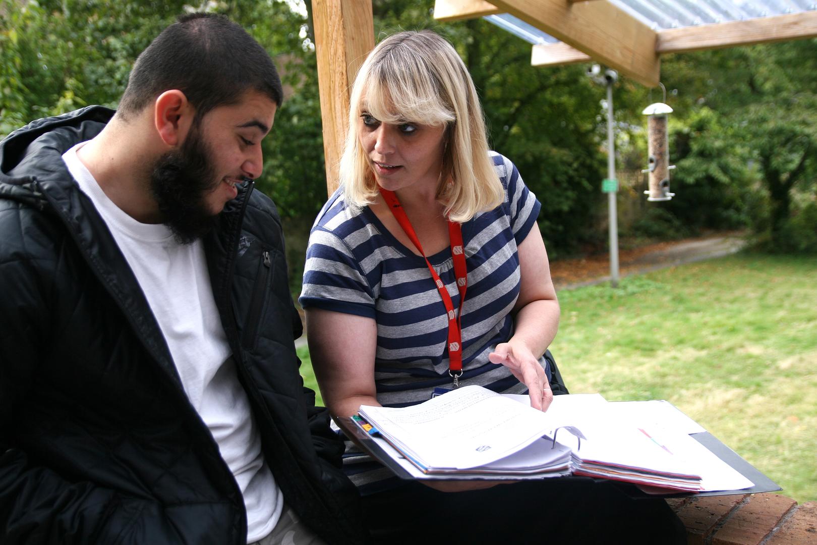 A member of staff helping a young person