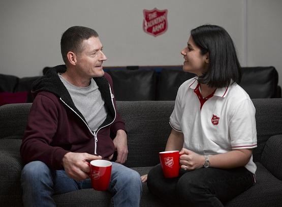A Salvation Army Officer and man chatting. 
