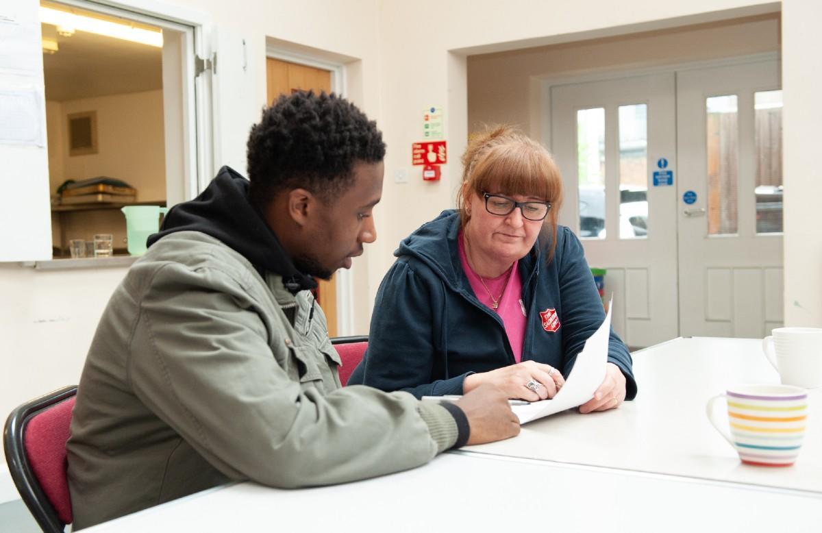 Officer at a debt advice clinic with a service user