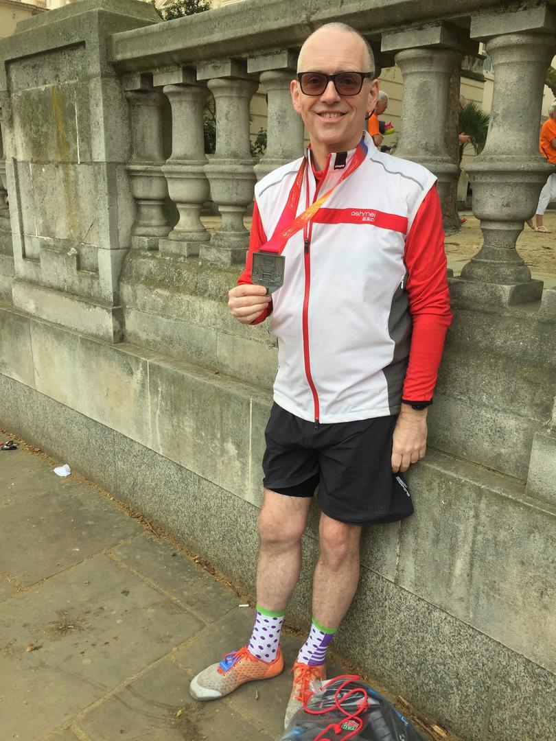 Jeremy Sandford holding his medal after completing London Marathon