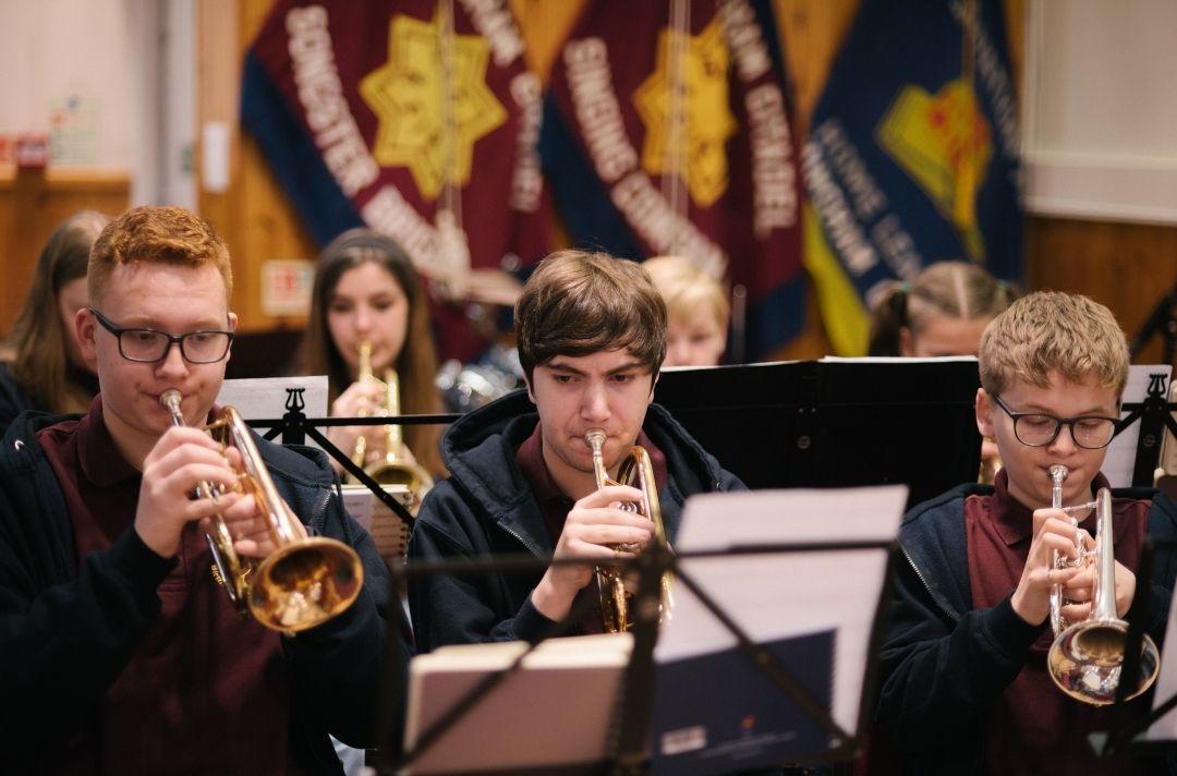 young people playing in a brass band