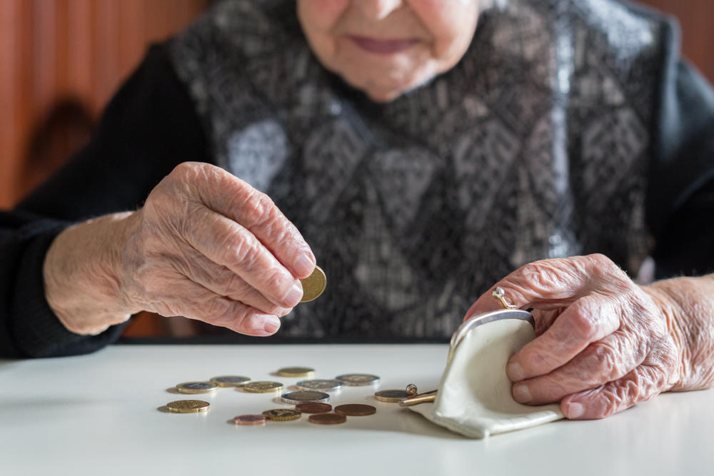 an older woman counting out her pennies