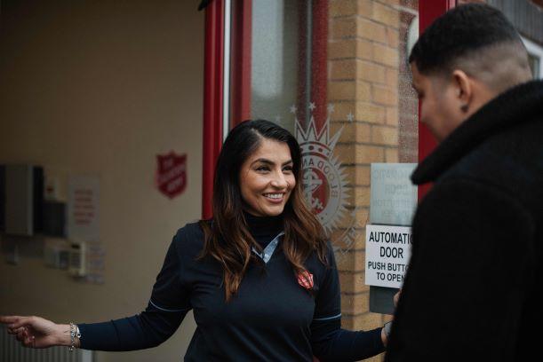 salvation army worker opening door to someone