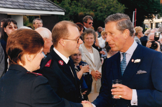 At a garden party in July 2000, the then Prince of Wales, on the right, speaks to Gary Robb from The Salvation Army, on the left.