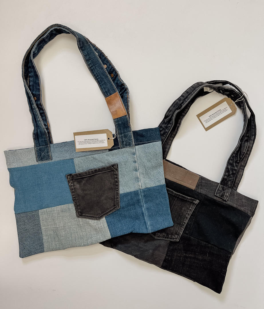 Denim bags made by inmates in HMP Five Wells. Image shows one bag made of light blue denim and one of dark blue denim