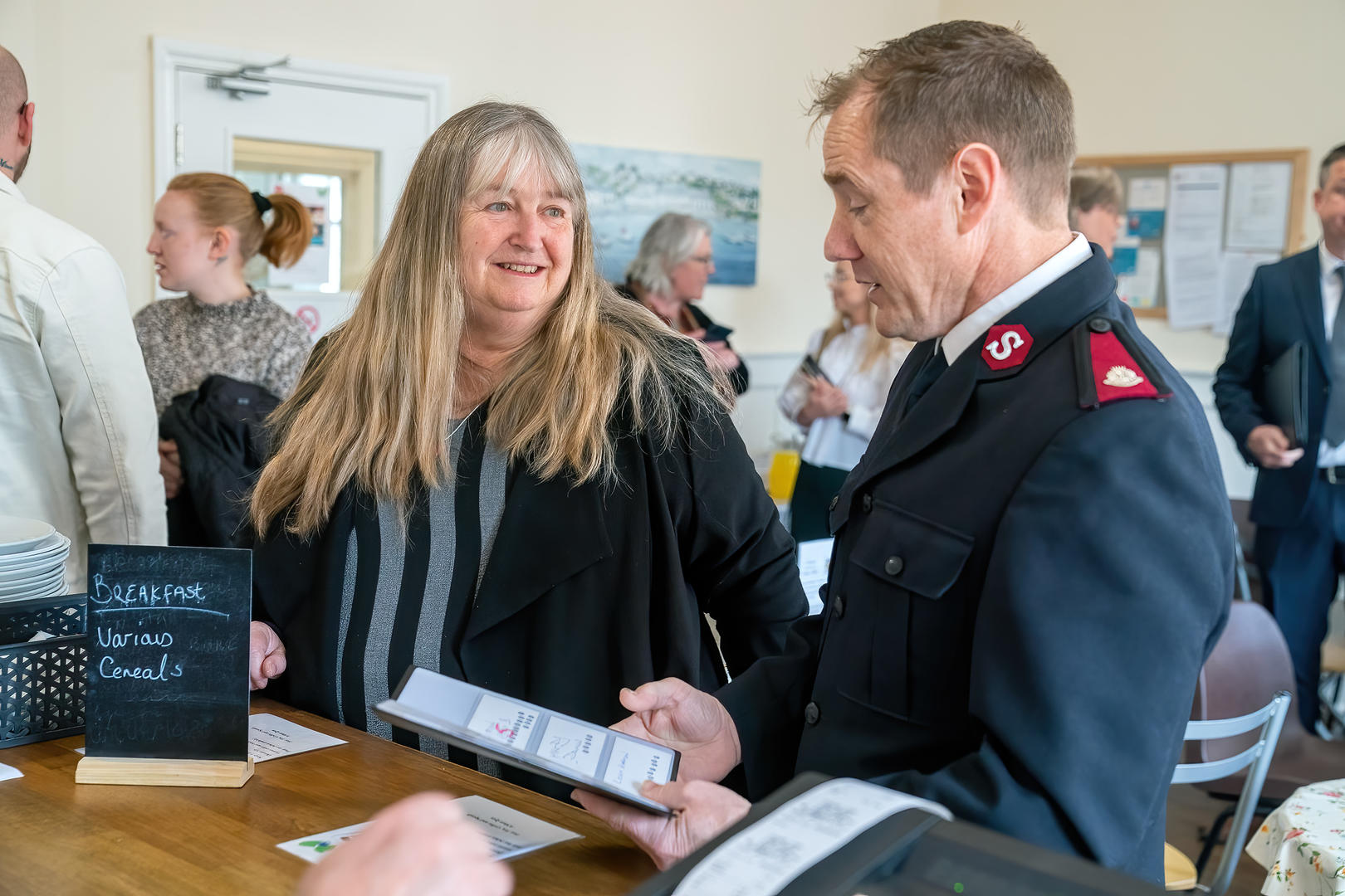 Julie James, Welsh Minister for Climate Change speaks with  Major Neil Duquemin from Neath Salvation Army at The Haven drop-in centre.