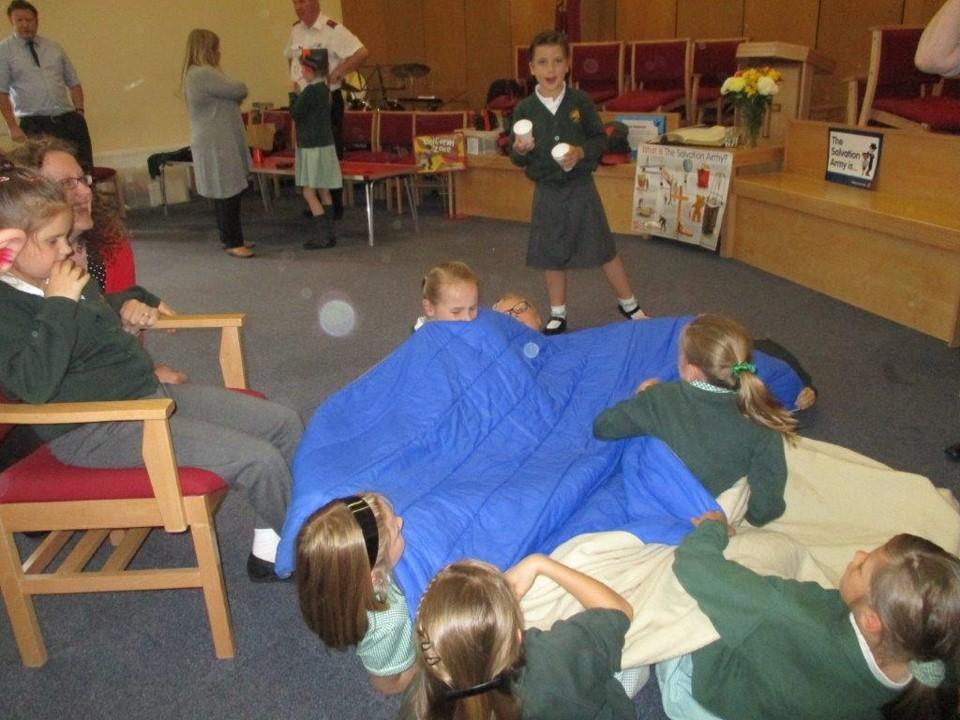 Pupils on the floor under blankets