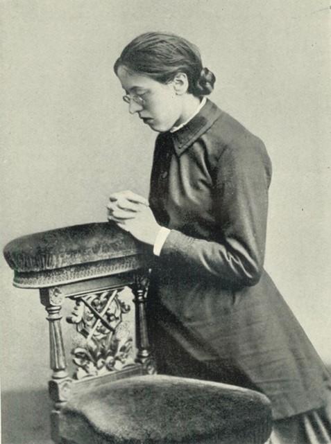 Marian Booth kneeling in prayer