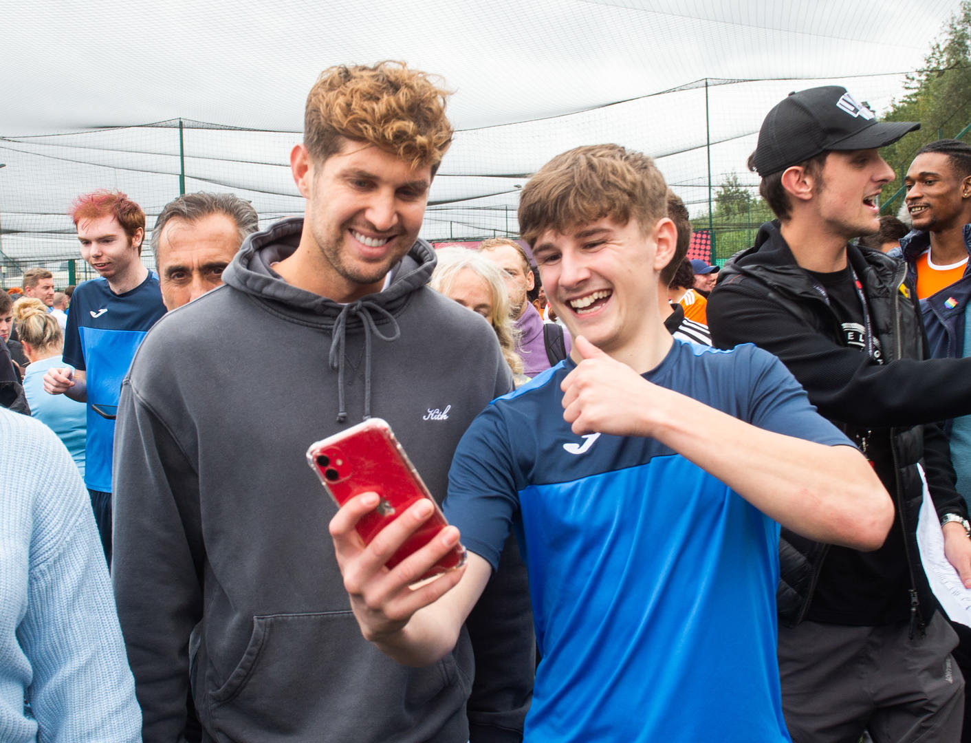 John Stones posing in a selfie taken by a young fan to the left of him