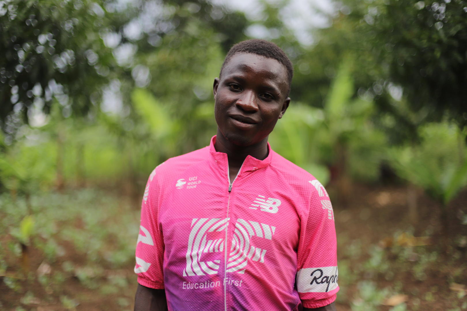 Young Ugandan man wearing pink cycling shirt