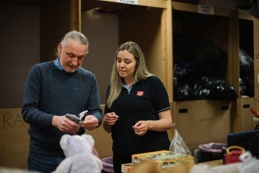 Salvation Army volunteers tagging items for charity shop
