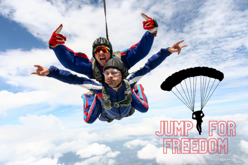 Two young men doing a tandem skydive are pulling faces at the camera as they fall though the air.