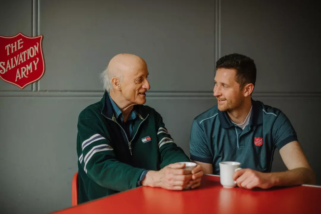 Two men sitting and having coffee at a Salvation Army Centre