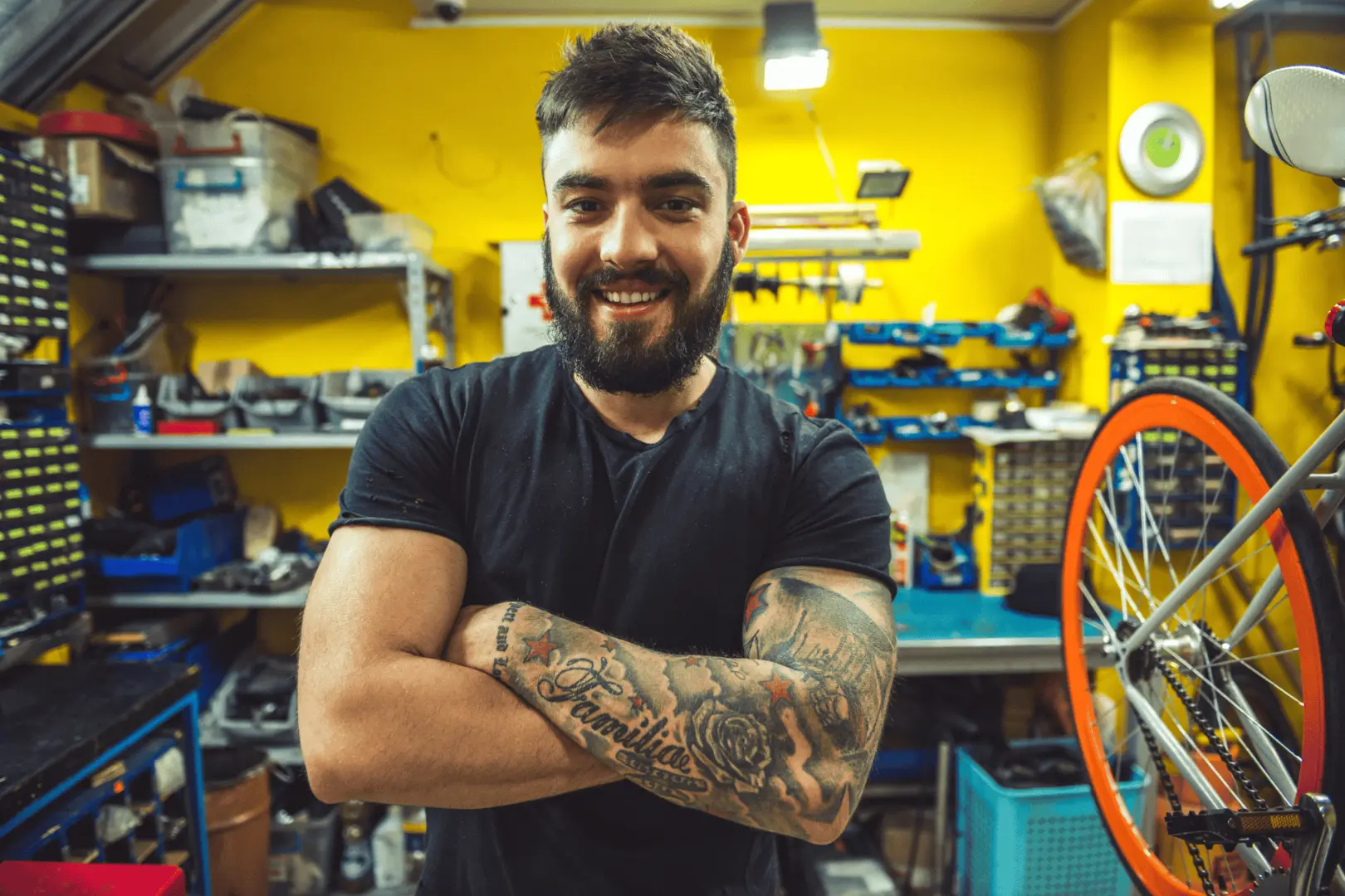 Man smiling at camera with bike behind