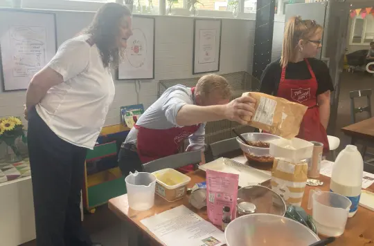 Picture of MP Robbie Moore baking 