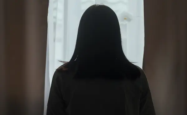 Person sitting in shadow