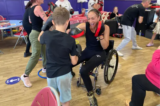 a picture of a woman and child with boxing gloves 
