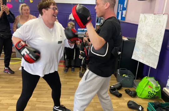 a picture of two people boxing and laughing 