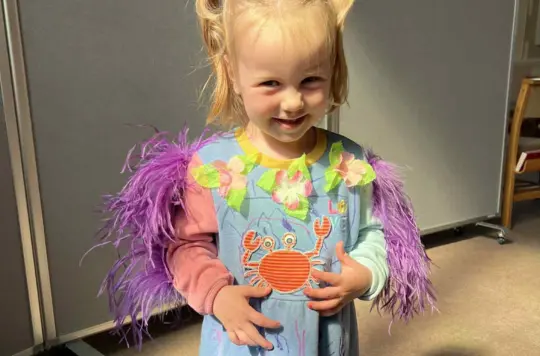 Little girl dressed up and smiling 