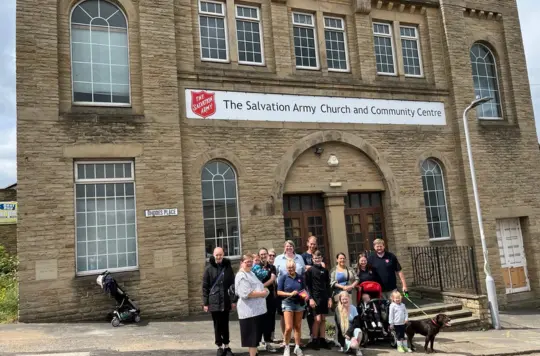 Shipley Salvation Army building with group of people 