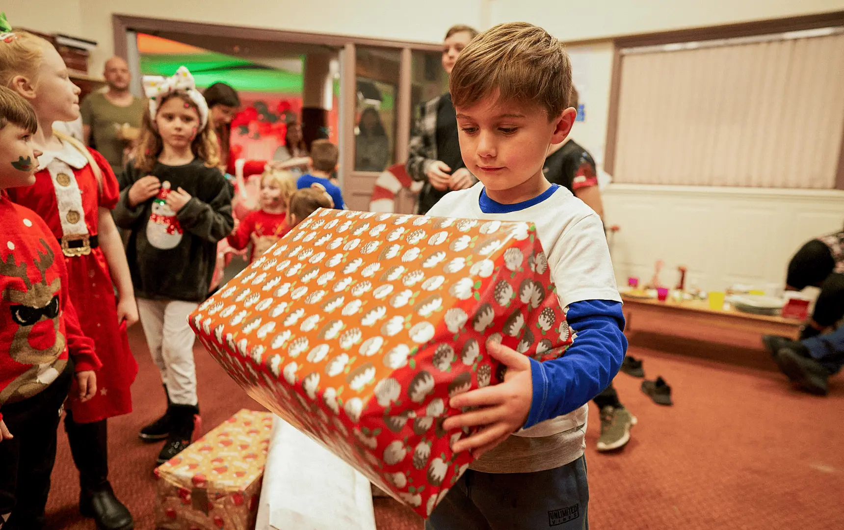 A child receiving a Christmas present from The Salvation Army