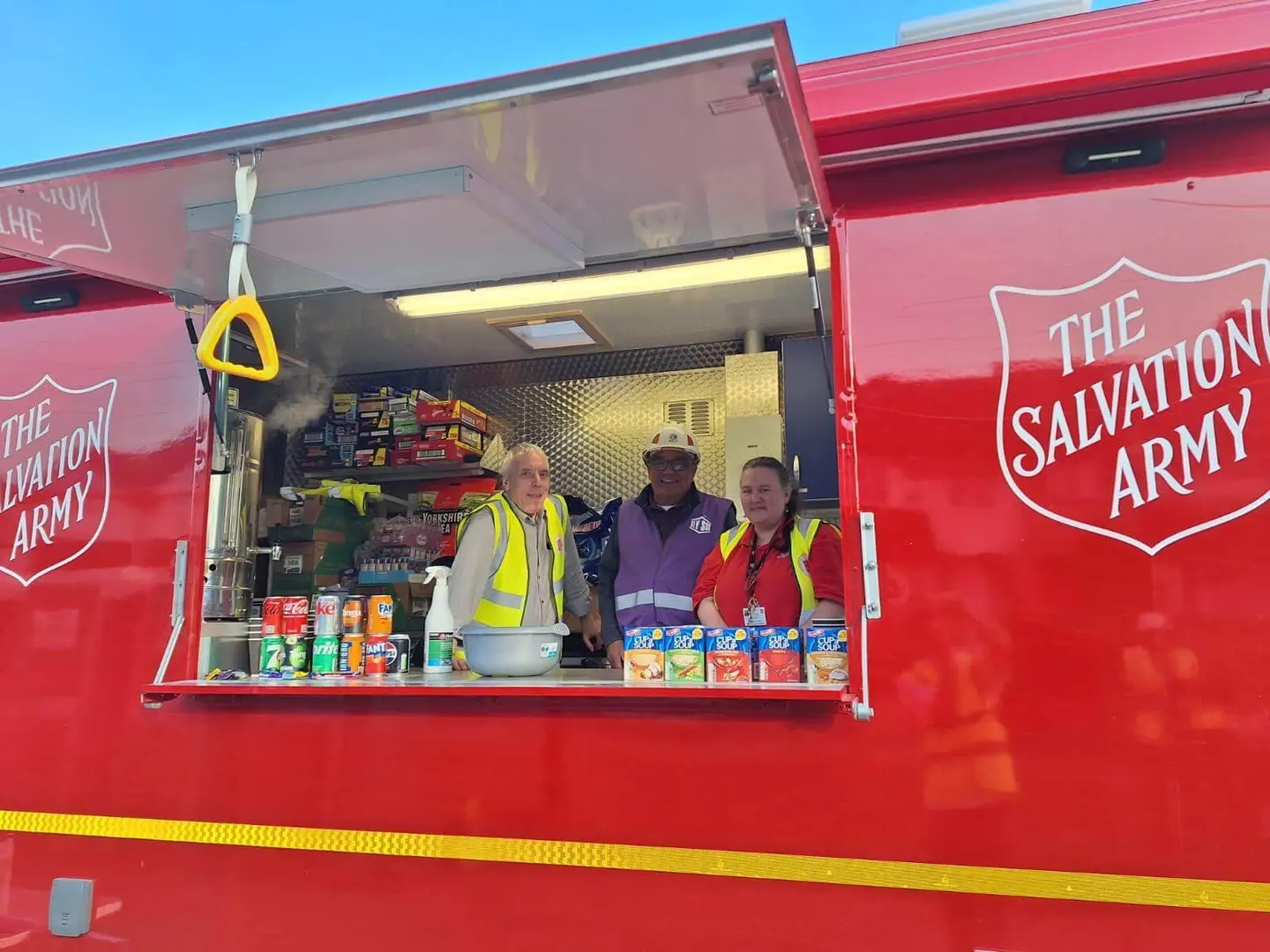 Salvation Army volunteers pictured in the IRV with a DIY SOS tradesman
