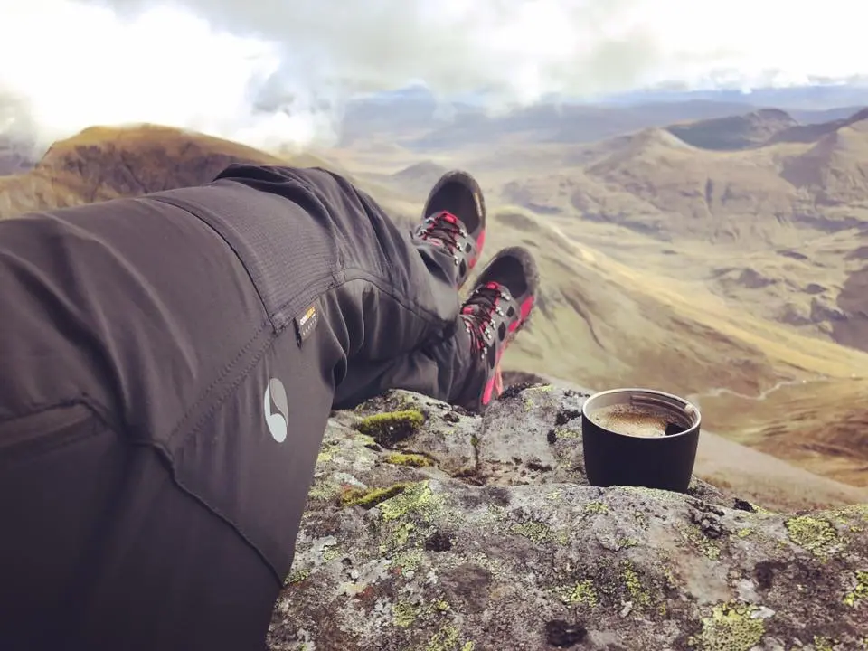 An image of a trekkers walking boots, overlooking Ben Nevis