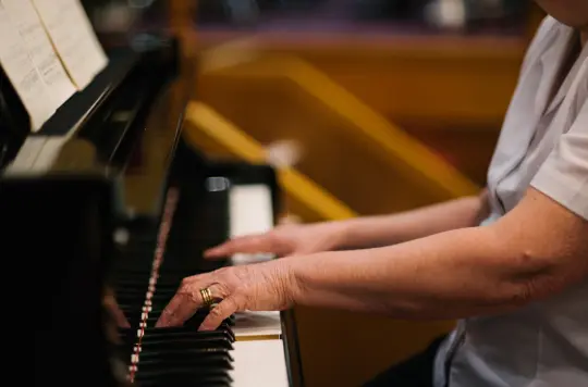 Stock picture of someone playing a piano 