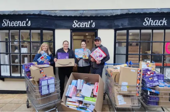 A picture of people holding Christmas presents