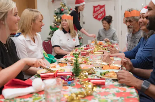 Stock image of people enjoying Christmas dinner