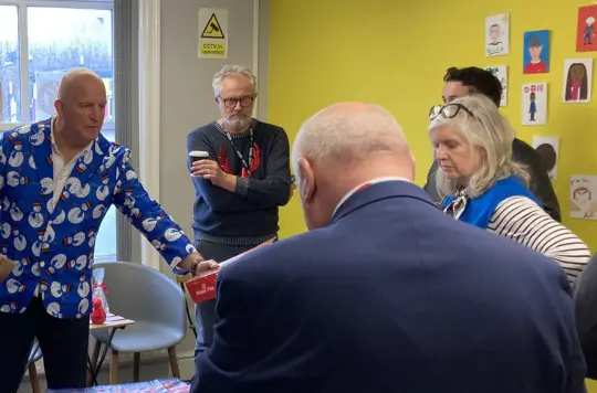 Group of people getting Christmas hampers ready 