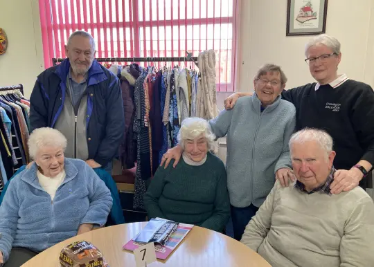 A group of people sitting and smiling at the camera 