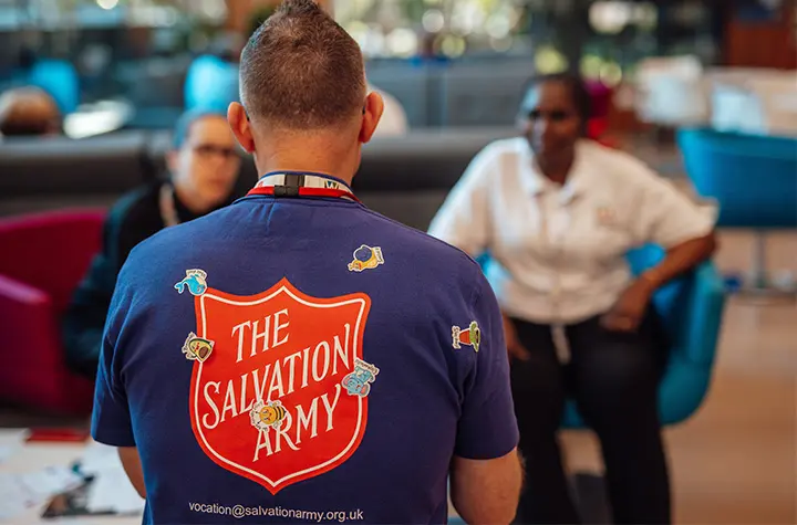 Salvation Army logo on the back of a shirt with stickers 