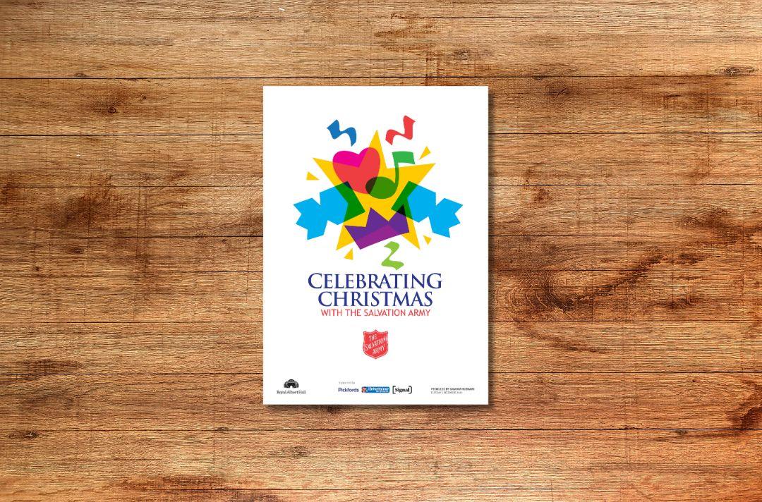 The front cover of the carol concert programme featuring a brightly coloured graphic of a Christmas cracker, musical notes, a star, love heart and crown.